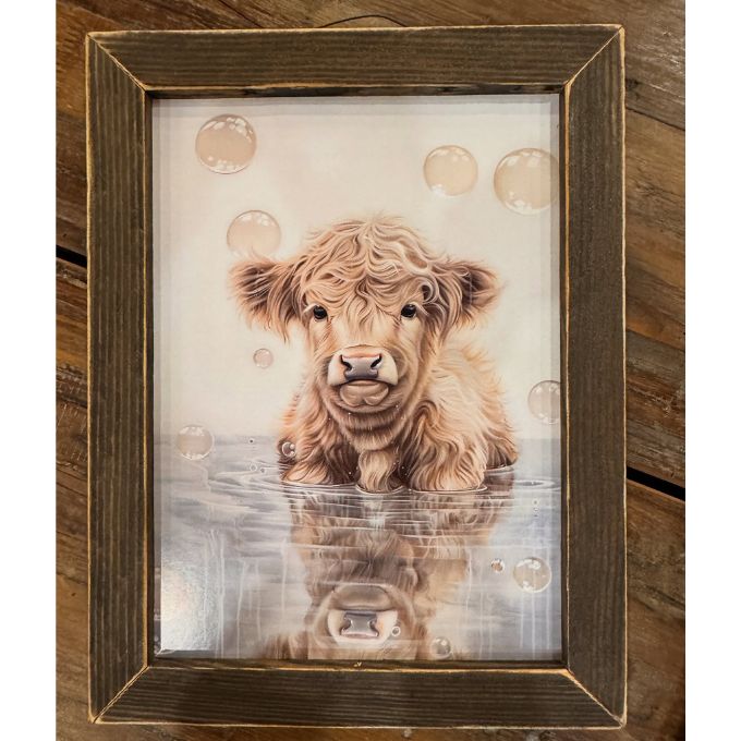 Framed artwork of a Highland cow with water and bubbles on a wooden background. Bubble Bath Babe available at Quilted Cabin Home Decor.