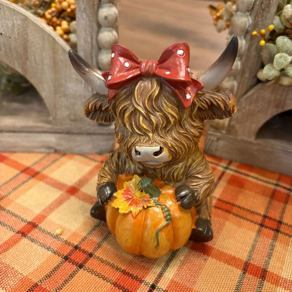 5" highland cow with bow and pumpkin available at quilted cabin in airdrie