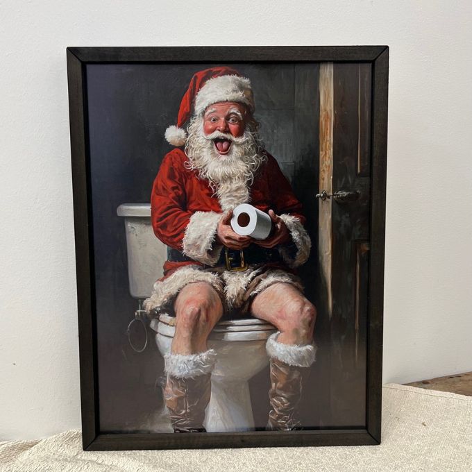Framed artwork of Santa Claus sitting on a toilet holding toilet paper. Potty Santa Box Frame available at Quilted Cabin Home Decor.