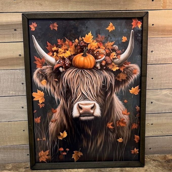 Framed artwork of a Highland cow with autumn leaves and pumpkins on a wooden background.  Fall Highland Cow Box Frame Wall Art available at Quilted Cabin Home Decor.