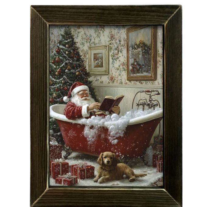 Framed artwork of Santa Claus reading a book in a bathtub with a dog and Christmas tree in the background. The Classic Santa Bathtub Framed Art Print is available at Quilted Cabin Home Decor.