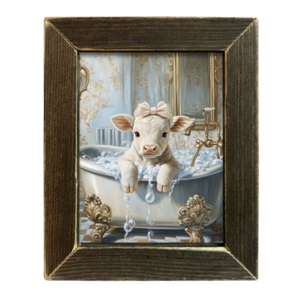 Framed artwork of a white calf in a bathtub with decorative elements. Bubble Bath Calf in Vintage Tub Framed Art Print available at Quilted Cabin Home Decor.