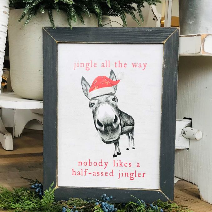 Framed Christmas-themed print with a donkey wearing a Santa hat and humorous text. Half Assed Jingler framed Art available at Quilted Cabin Home Decor.