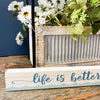 Life is better on the Water Shelf Sitting Sign available at Quilted Cabin Home Decor