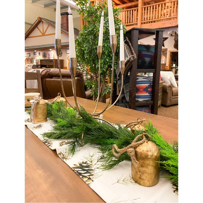  Woodland pines table runner is a neutral coloured runner with pine cones and boughs on it. Available at Quilted Cabin Home Decor.