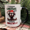 Mug with Christmas-themed design featuring a dog and humorous text, placed on a table with greenery in the background.  Christmas Spirit Mug available at Quilted Cabin Home Decor.