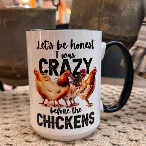 Mug with chicken design and text 'Let's be honest I was crazy before the chickens' on a textured surface.  The Crazy Chicken mug is available at Quilted Cabin Home Decor.