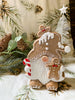 Gingerbread gnome figurine has a full beard and is holding a candy cane and gingerbread man. It is available at Quilted Cabin Home Decor.