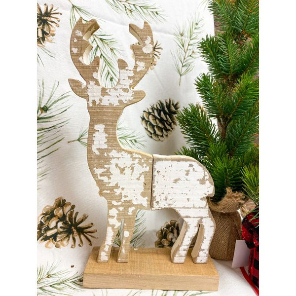 A white painted and distressed wooden reindeer that will stand as part of your christmas decor.