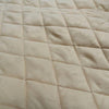 Close-up of beige quilted fabric with diamond pattern. Pine Panels King Quilt Set available at Quilted Cabin Home Decor.