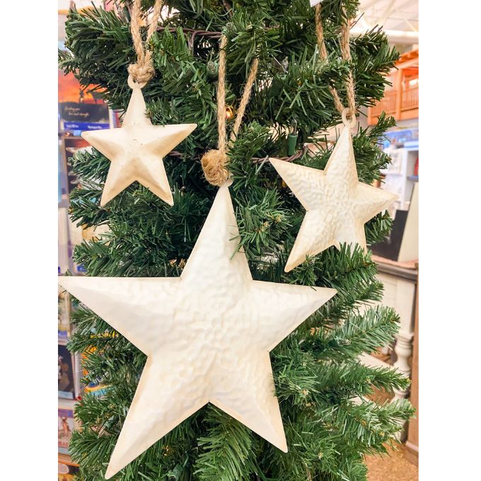 White Star Ornaments - Three Sizes are white hammered metal stars that hang from jute. Available at Quilted Cabin Home Decor.