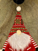 The Kringle Gnome tree skirt in green is shown. It has a festive gnome appliqued on it along with snowflakes. It is trimmed in faux fur.