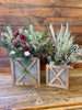  Wood trimmed galvanized corrugated metal boxes in two sizes are filled with floral. The boxes have an wood strapping on the outside in the shape of an X and all of the edges are faced with wood.   