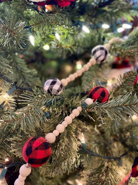 This Plain and Natural Beaded Garland is a string of natural coloured wooden beads separated by a larger black and white check or red and black check bead. 