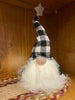 The Black and White LED Gnome has a fuzzy whispy beard with a black and white plaid hat with a grey star on the top. The body of the gnome lights with an LED light. 