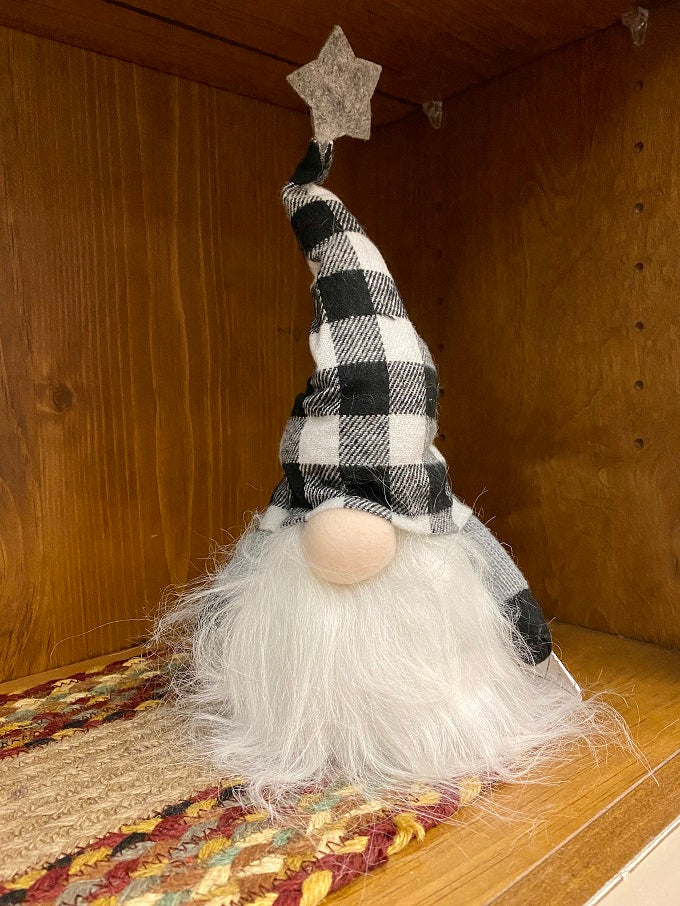 The Black and White LED Gnome has a fuzzy whispy beard with a black and white plaid hat with a grey star on the top. The body of the gnome lights with an LED light. 