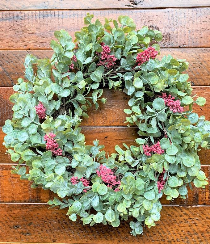 The wreath of the holiday eucalyptus collection. White dusted eucaluptus leaves with red berries incorporated throughout. 