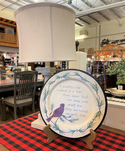 This round wooden plate shows a red cardinal on a cream coloured painted background and features the text:  A beautiful red cardinal is a sign from above that our loved ones aren't far...they surround us with love.