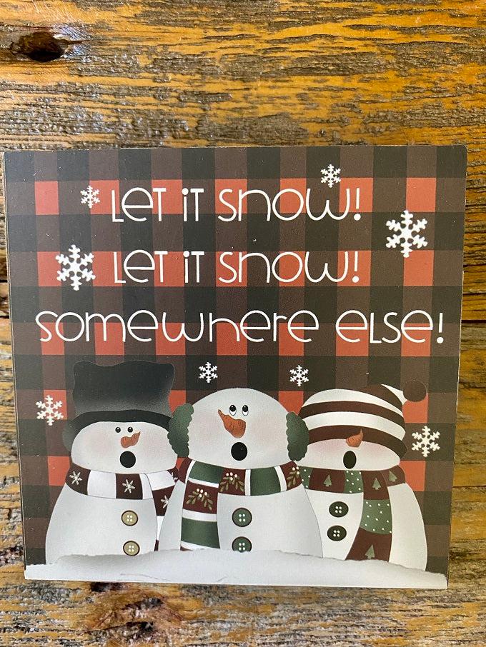 A snow friends block sign that says Let it Snow Let it Snow Somewhere Else. 