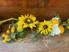 close up of large bright yellow sunflowers and lemons as part of the sunflower lemon garland