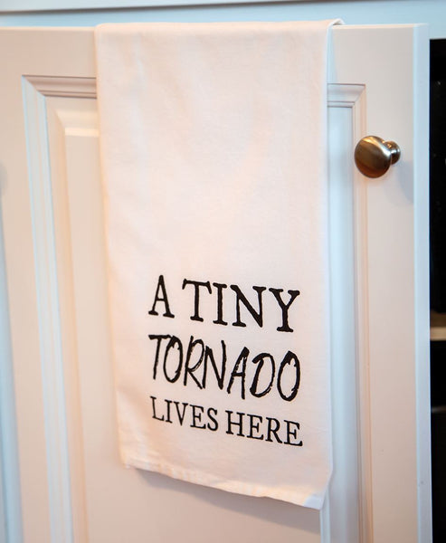 A tiny Tornado Lives Here Dish Towel available at Quilted Cabin Home Decor.