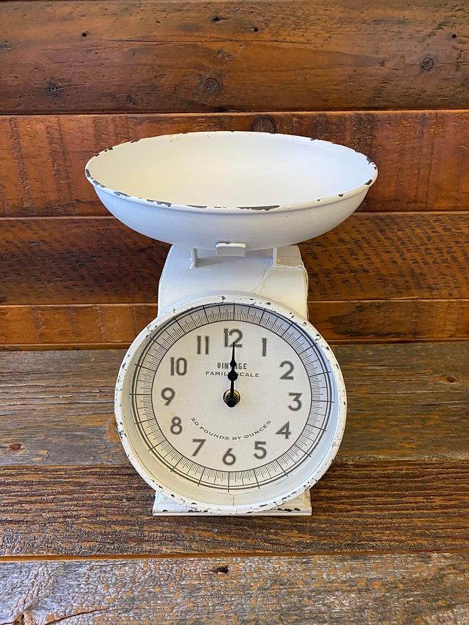 The vintage white scale with clock