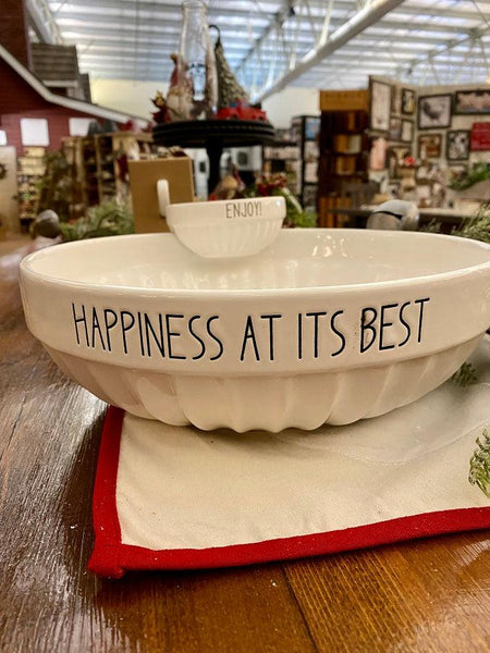 A pretty white ceramic chip and dip bowl set. The dip bowl sits on the edge of the chip bowl. The Chip bowl says Happiness at its Best and the dip bowl says Enjoy. All words are printed in black.
