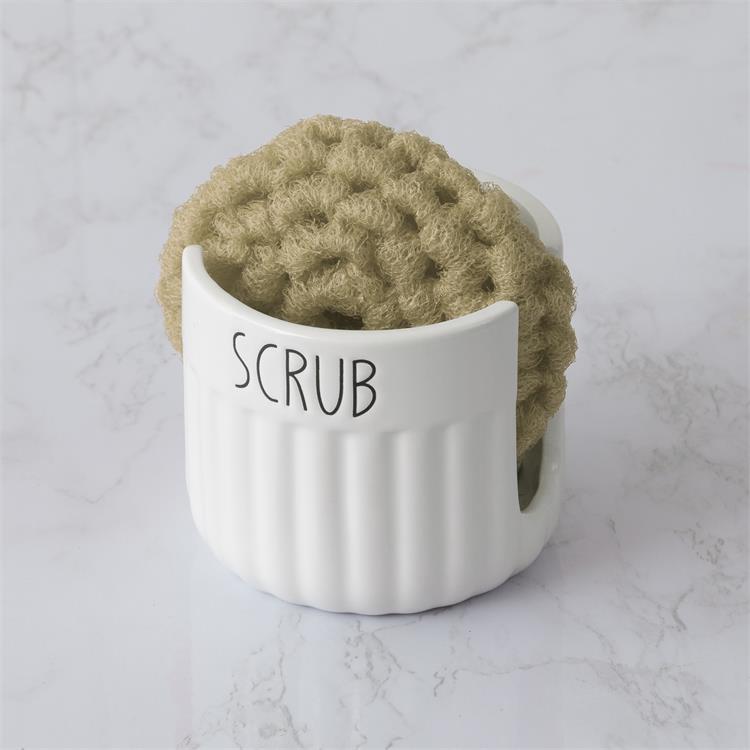A white ceramic cup that has split sides to hold a sponge. The word scrub is printed in black on the outside rim. 