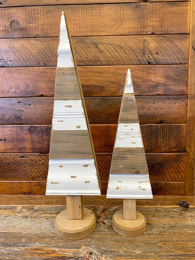 Rustic White wooden trees shown in both the large and small size. They are distressed white and a natural wood colour. The base is round. 