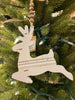 The reindeer Chippy wood ornament. The ornament is white and at the top is natural coloured brown beads strung on a jute hanger.