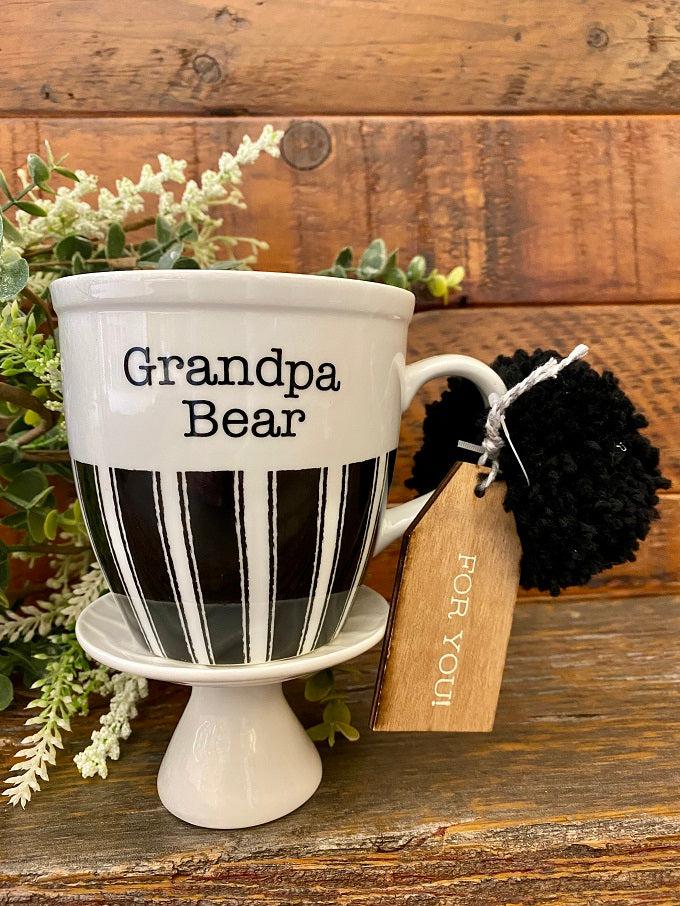 The Grandpa Bear mug has black and white stripes along the bottom half of the mug. It is printed on both sides. 