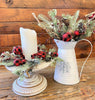 A small wreath is used as a candle ring and a grouping of floral picks from the country holiday buffalo plaid collection.