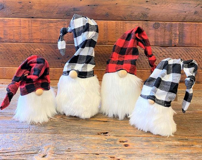 Red and black checked hats make these gnomes perfect for the holidays. They have a full bushy faux fur beard and there is wire in the hat that allows you to move the hat in a number of different angles. The red and black hat gnomes are shown here with black and white checked hat gnomes.