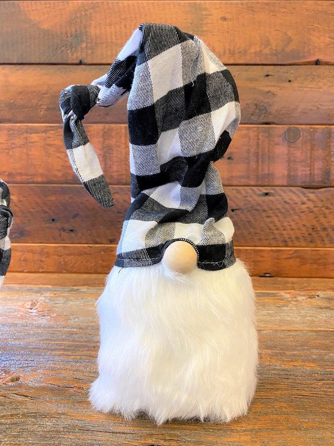 This is a black and white checked hat gnome. The gnome has a bushy faux fur beard and wire in the hat allows you to move the hat in a number of directions.