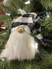 This is a black and white checked hat gnome. The gnome has a bushy faux fur beard and wire in the hat allows you to move the hat in a number of directions. It is shown here in a Christmas tree.