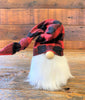 This is a red and black checked hat gnome. The gnome has a bushy faux fur beard and wire in the hat allows you to move the hat in a number of directions.