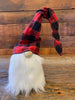 This is a red and black checked hat gnome. The gnome has a bushy faux fur beard and wire in the hat allows you to move the hat in a number of directions.