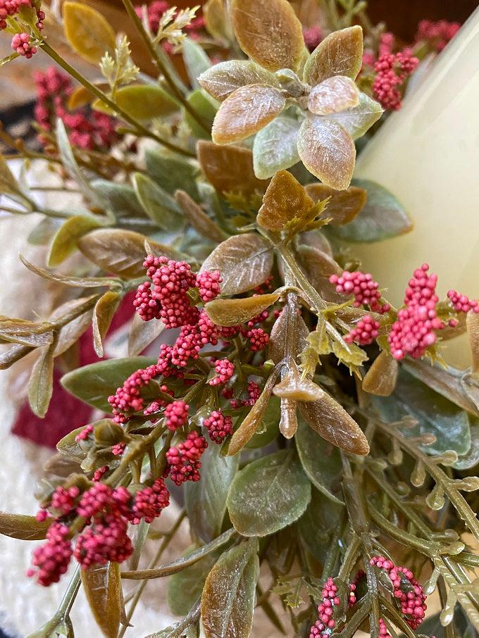 The red  weatherly buds candle ring is shown here. Red coloured stems is mixed with soft green shades making for a full candle ring.