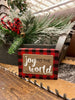 Joy to the World Shelf sitter sign has a wood look plaque on a red and black buffalo check printed block.