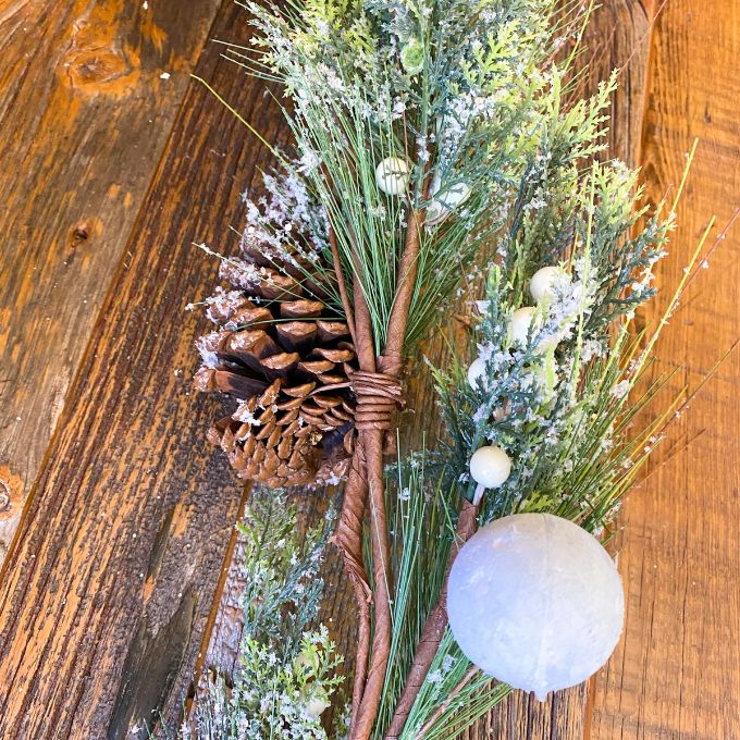 Frosty White Berry and Bell Pine Garland available at Quilted Cabin Home Decor.