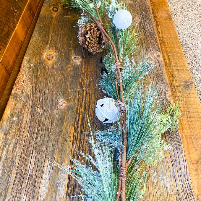 Frosty White Berry and Bell Pine Garland available at Quilted Cabin Home Decor.