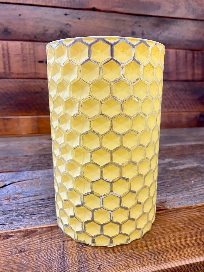 A large yellow glass honey comb jar.