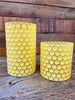 Two Yellow glass jars that are textured like honeycomb. A large and a small glass jar is shown