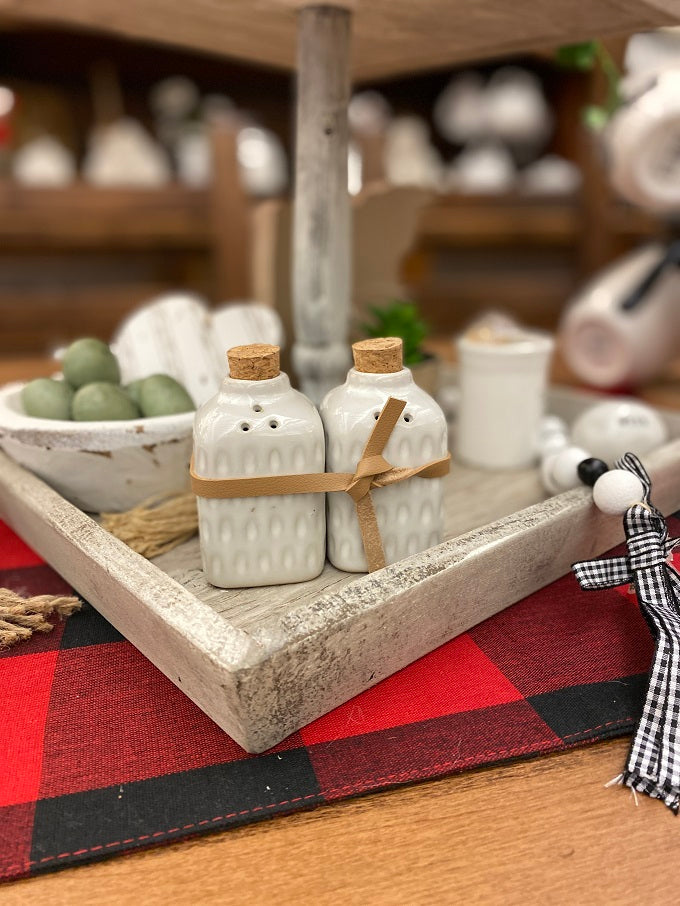 Glazed Salt and pepper shakers available at quilted cabin Home decor. Cork top and tied with a leather strap for easy gifting.