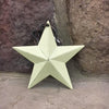 A close up photo of a ivory coloured farmhouse barn star. It is made of metal and can be hung using the green and ivory gingham fabric hanger. It is 5" wide.