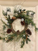  The Country snowberry floral wreath is filled with white berries, pinecones and pine and other greens. A few silver jingle bells complete this full wreath. 