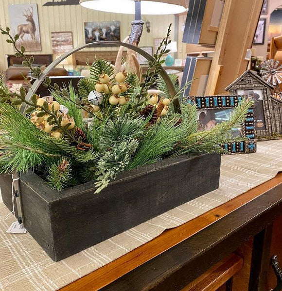 A black wooden tray filled with the Country snowberry floral picks. White berries, pinecones, a silver jingle bell and pine and other greens fill the tray.