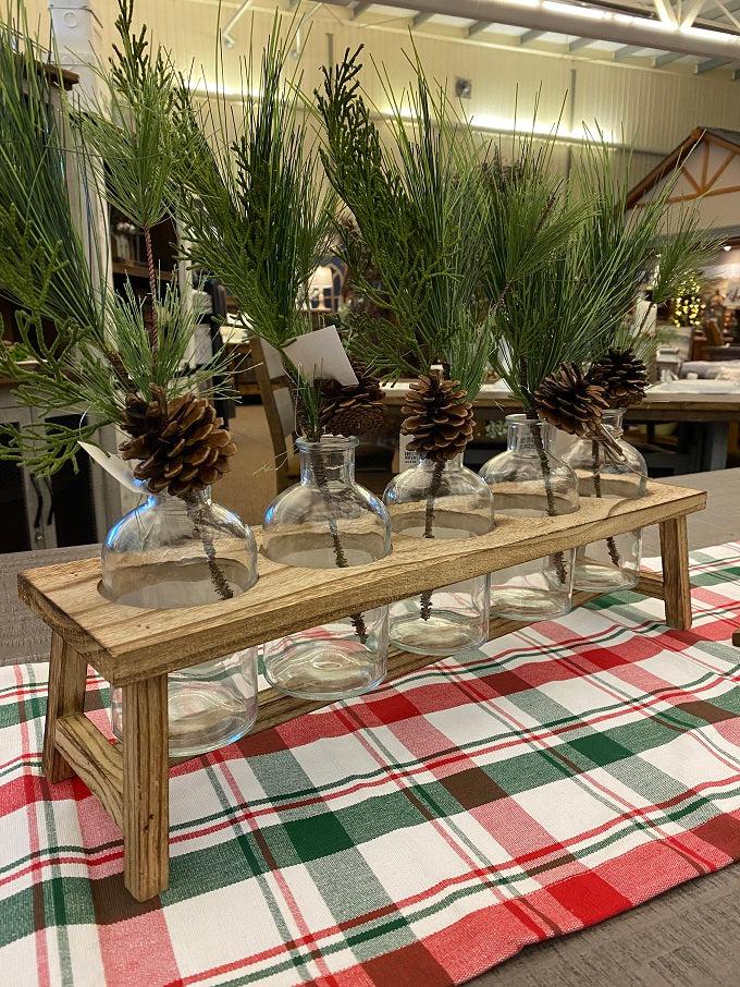 The Cedar Needle and Pine Cone Spray is the perfect green floral for holiday decorating. A large piece of cedar and pine together with one pine cone on a bendable wire. Shown here in a floral container