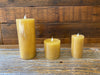 Three honeycomb candles are pictured. One is 7" tall, one is 3" tall and one is 4" tall. 