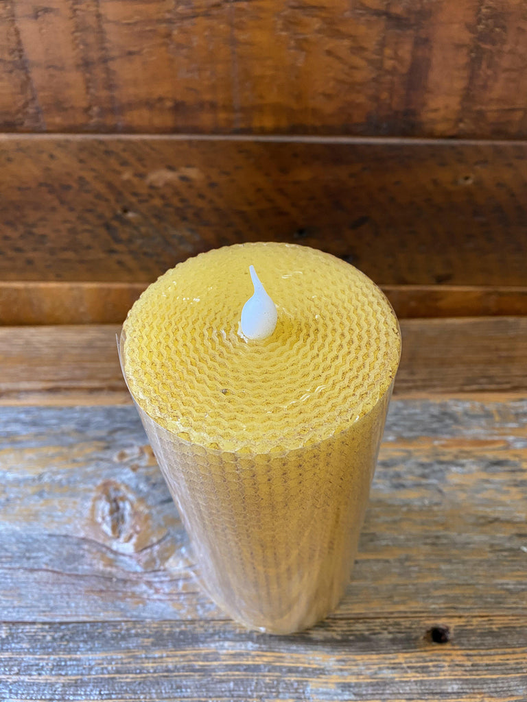 A shot showing the honeycomb candle top to show how this candle looks like rolled honeycomb..